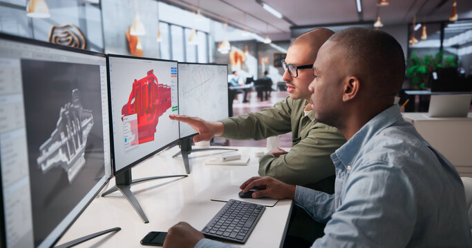 Two Mechanical Engineers Are Working Together On 3D CAD Designs