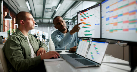 Two Team Members Discuss Project Schedule And Plan Tasks