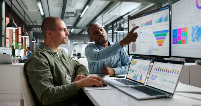 Two Financial Analysts Are Looking At Dashboards