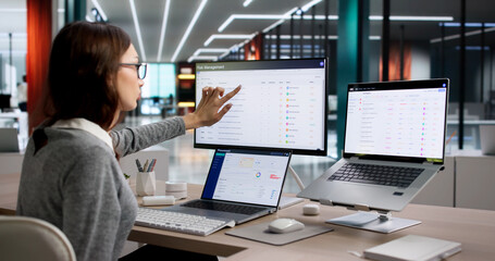Woman Analyzes Corporate Risk Data On Laptop