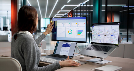 Young Woman Using Laptop To Review Electronic Invoices