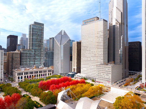  Aerial Drone View of Millennium Park Jay Pritzker Pavilion Surrounded by Vibrant Autumn Fall Foliage with Chicago Loop Skyscrapers and Blue Sky, Illinois, USA&rdquo;
