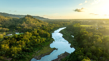 Golden aerial view of winding forest river © Zidane