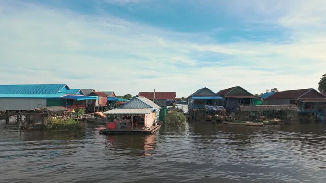 A floating village on Tonle Sap Lake near Siem Reap, Cambodia, showcases traditional stilt houses and boats. This community relies on the lake for livelihood and transportation.
