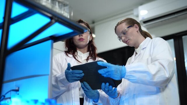 Environmental scientist testing water quality sample for microplastics and chemical contaminants in laboratory.