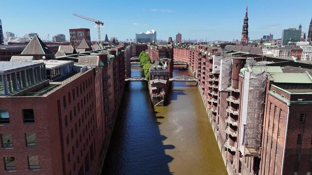 Hamburg, Germany - 28 May 2026: Aerial view of the Speicherstadt warehouse district with its red brick buildings, canals, and the Elbphilharmonie in the distance.