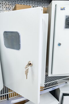Metal electrical control panel enclosure by IEK featuring a sturdy white finish and a built-in transparent window for monitoring interior components  
