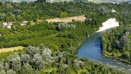 Fototapeta premium Aerial View of Tanaro River Winding Through Lush Piedmont Valley