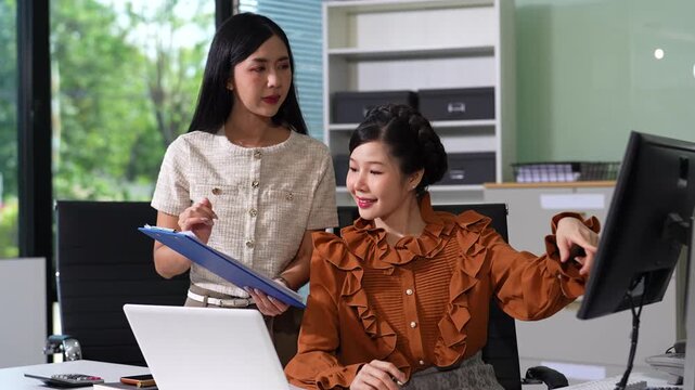 Business consultants discuss tax, merger strategy and restructuring in modern office.