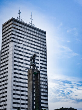 The iconic Welcome Monument or Monumen Selamat Datang with a skyscraper background in Jakarta