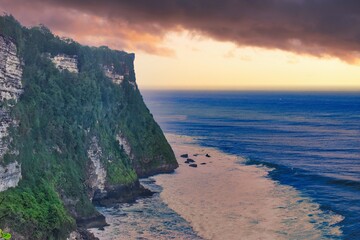      Bali, Indonesia - June 7, 2022: The Uluwatu Temple on a Cliff. Perched dramatically on a steep cliff, Uluwatu Temple stands at an elevation of 97 meters above sea level, offering breathtaking oce © Scotts Travel Photos