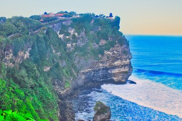      Bali, Indonesia - June 7, 2022: The Uluwatu Temple on a Cliff. Perched dramatically on a steep cliff, Uluwatu Temple stands at an elevation of 97 meters above sea level, offering breathtaking oce © Scotts Travel Photos