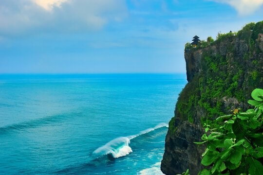 




Bali, Indonesia - June 7, 2022: The Uluwatu Temple on a Cliff. Perched dramatically on a steep cliff, Uluwatu Temple stands at an elevation of 97 meters above sea level, offering breathtaking oce