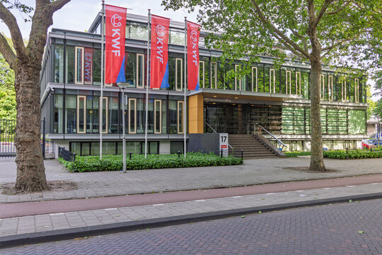 Amsterdam, Netherlands, 23 May 2026. The exterior facade of the KWF Kankerbestrijding (Dutch Cancer Society) headquarters office building with red promotional flags.