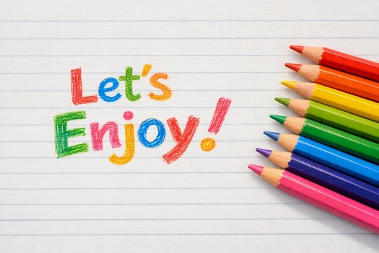 Rainbow 'Let's Enjoy!' message and colorful pencils on lined paper