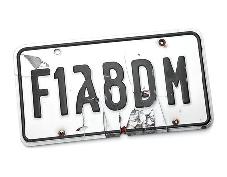 Damaged White License Plate with Cracked Surface Isolated on White Background