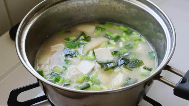 Healthy Japanese Miso Soup with Tofu and Seaweed on Stove	