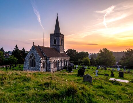 Historic Stone Church Standing in Rural Graveyard at Colorful Sunset