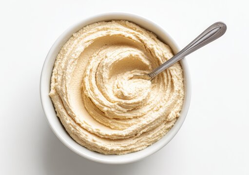Creamy Hummus Swirl in a White Bowl with Spoon.