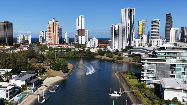Aerial View of Speedboat Navigating Gold Coast Canal with City Skyline