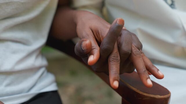 Nearby couple embrace. Closeup of lovers gently holding hands outside in soft light. An affectionate pair quietly expressing love with intertwined fingers during peaceful outdoor scene