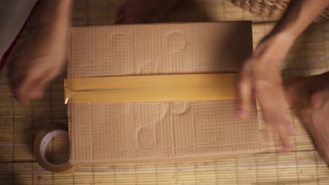 Hand Sealing Cardboard Box with Packing Tape