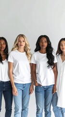 Obraz premium Four diverse women stand together, showcasing unity and individuality in simple attire.