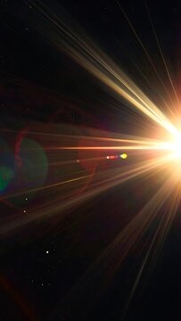 A bright light source radiates colorful beams in a dark space