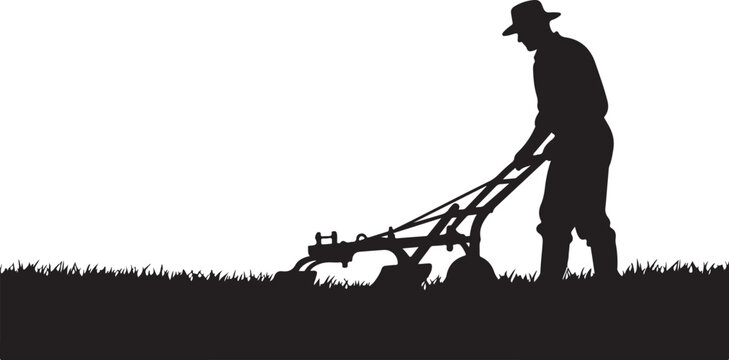 Man in silhouette using a rototiller on grassy ground