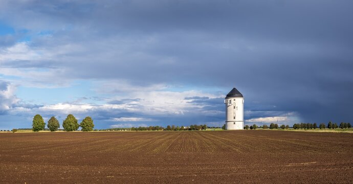 Water tower Cr&ouml;lpa-L&ouml;bsch&uuml;tz, field landscape with ploughed field under a stormy sky with dramatic clouds, near Naumburg, Saxony-Anhalt, Germany
