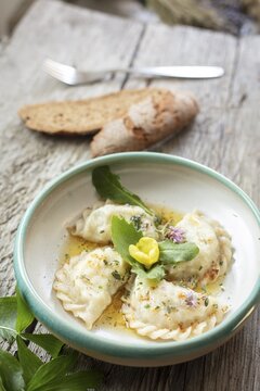 Carinthian noodles filled with herbs and cream cheese, melted butter, bread and lovage, Irschen, Carinthia, Austria