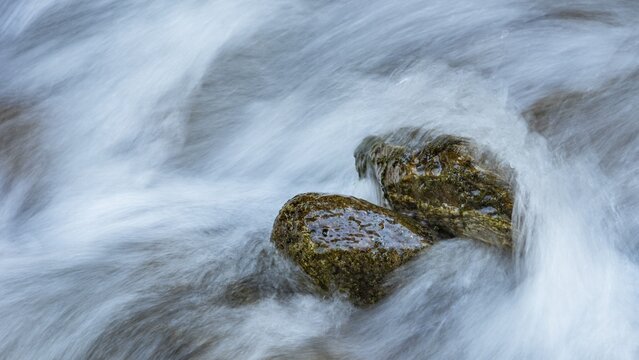 Water laps rocks in Gartel waterfall in Hohe Tauern National Park, Austria