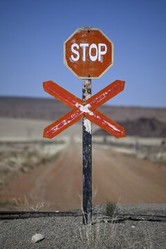 Stop sign at an ungated level crossing on the L&uuml;deritz-Keetmanshoop railway line, near Goageb, Karas region, Namibia
