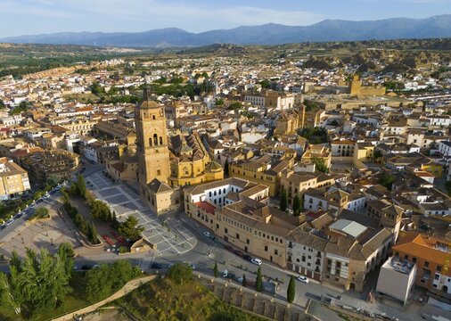 Aerial view of a city with historic church in the centre, surrounded by buildings and landscape, mountains in the background, aerial view, Cathedral, Catedral de la Encarnaci&oacute;n de Guadix, Guadix, Sierra Nevada, Granada, Andalusia, Spain