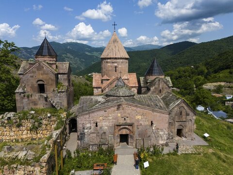 Historic Armenian monastery against a mountain backdrop and blue sky, aerial view, Goshavank Monastery, Tavush Province, Armenia