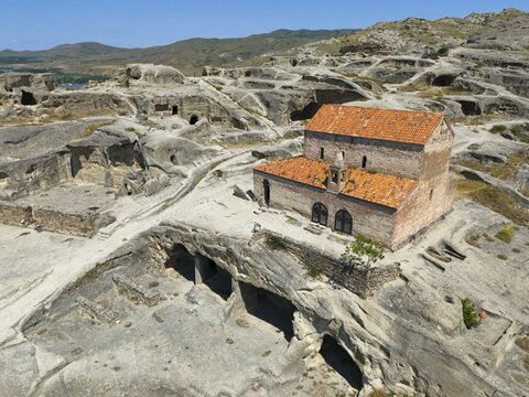 Fascinating ruins of Uplistsikhe with orange tiled roofs in the middle of a rocky landscape, aerial view, Princes' Church, Uplistsikhe cave town, Uplistsikhe, Inner Kartlia region, Shida Kartli, Georgia