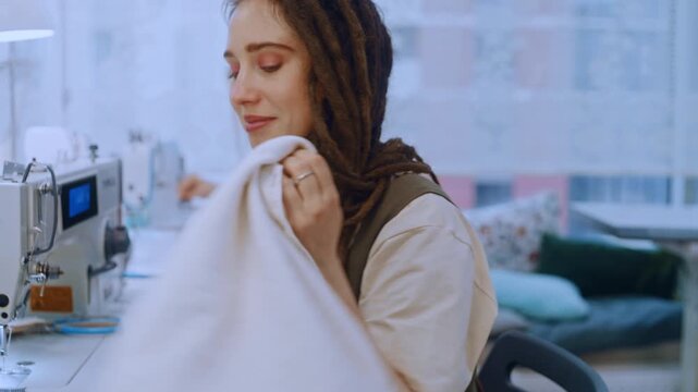 Professional women sewing clothes on industrial machines in a garment factory or design studio