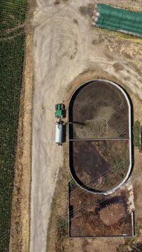 Aerial view of a farm slurry pit with a tractor