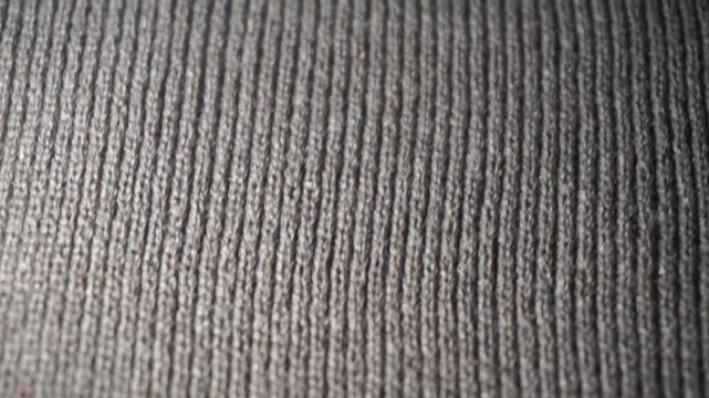 Brown natural texture background of knitted wool textile material. Brown cotton woven canvas texture.

