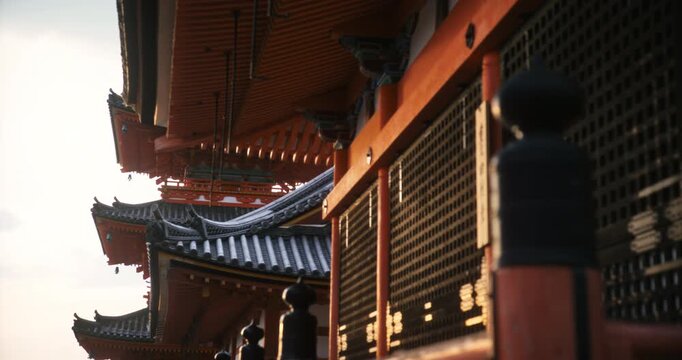 Sunset glow on surface of ancient Japanese temple - steady cam medium shot
