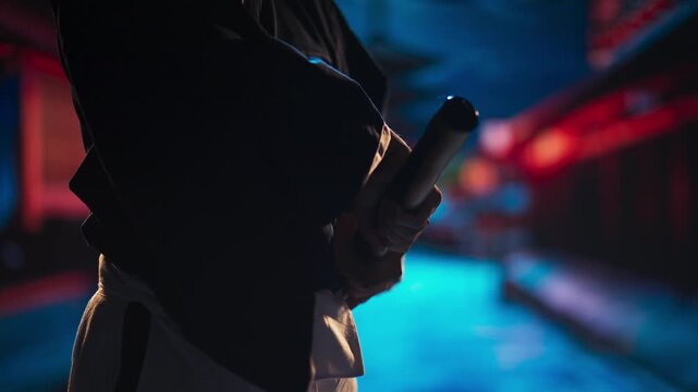 Close-Up of Ninja Hand Holding Sword Beside Waist