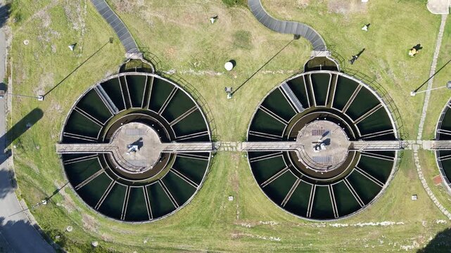Symmetrical circular clarifiers at a wastewater treatment facility processing sewage and purification