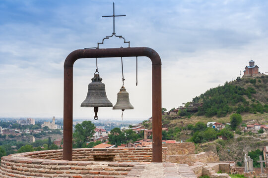 Two church bells on a brick wall at Narikala Fortress in Tbilisi