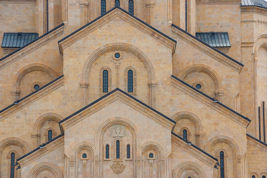 Stone facade features grand arches at Holy Trinity Cathedral in Tbilisi