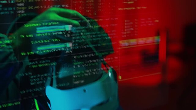 Masked hacker hacking computer. anonymous hacker wearing mask and black hoodie in dark room. online scam and cyber security threat.
