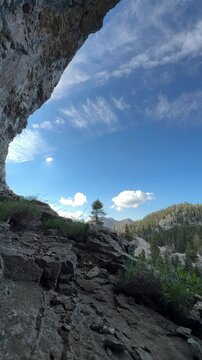 View from inside a massive mountain cave over pine forest in Gidengelmez, Turkey.