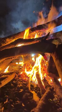 Vertical social media background of night fire, smoldering heat and colored smoke