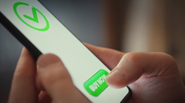 Pay button on mobile screen of online store is tapped by man's finger, completing purchase. app shows brief waiting cue, then flashes &lsquo;payment successful', confirming secure one-tap mobile payment