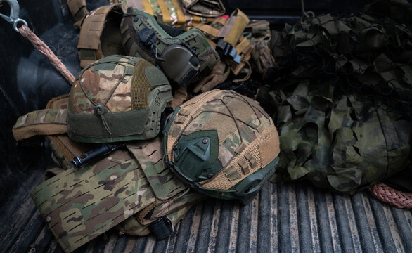 Modern ballistic helmets and tactical vest in camouflage pattern, military combat equipment
