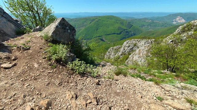 Rugged trail winds through rocky, mossy terrain. Ovcar Kablar Gorge. Balkans, Serbia